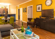 Thumbnail 41 of 55 - a living room with a couch and chair and a coffee table with a vase on it