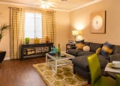 Thumbnail 43 of 55 - a living room with a brown couch and green chairs