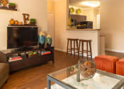 Thumbnail 25 of 55 - a living room with a couch and a coffee table