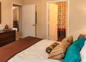 Thumbnail 51 of 55 - a bedroom with a bed and a dresser