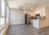 Thumbnail 11 of 19 - Dining area with kitchen and large window view
