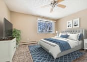 Thumbnail 11 of 32 - a bedroom with a large bed and a ceiling fan at Heritage Hills Apartments, Bloomington, 55437