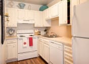 Thumbnail 10 of 27 - Gourmet Kitchen with White Cabinetry at Desert Creek, New Mexico, 87107