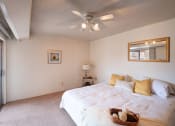 Thumbnail 14 of 27 - Bedrooms With Lighted Ceiling Fan at Desert Creek, Albuquerque, New Mexico