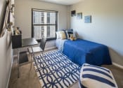 Thumbnail 13 of 39 - Bedroom photo with large window and blue furnishings at Eden Commons, Chicago