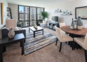 Thumbnail 6 of 39 - Living room layout with floor to ceiling windows, seating, and interior furnishings at Eden Commons, Illinois