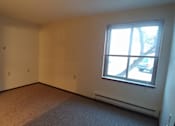Thumbnail 8 of 8 - A room with a window and a car parked outside.