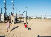 Thumbnail 17 of 18 - Boy swinging on a swing at the beach at Brookwood at Bay Shore in Bay Shore, NY 11706