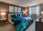Thumbnail 14 of 40 - Bedroom with teal bedding and contemporary decor at The Brook At Columbia Apartments, Maryland
