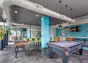 Thumbnail 3 of 26 - Community Room with Pool Table and Foosball at Greenway at Fisher Park, Greensboro, NC, 27401