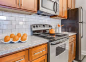 Thumbnail 29 of 35 - Electric Range In Kitchen at Greenway at Stadium Park, North Carolina, 27401