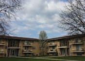Thumbnail 7 of 33 - an apartment building with a tree in the middle in front of it