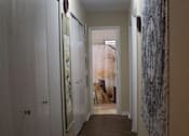Thumbnail 18 of 18 - a hallway with a wooden floor and closets