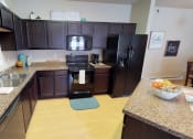 Thumbnail 6 of 26 - Wooden cabinets at Stonebridge Villas Apartments, Minot, ND