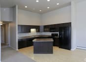 Thumbnail 20 of 26 - Kitchen with cabinets and appliances at Stonebridge Villas Apartments, Minot, 58703