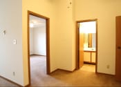 Thumbnail 9 of 18 - Image of a carpeted master bedroom and bathroom