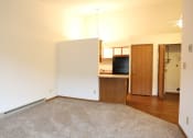 Thumbnail 7 of 18 - Image of a carpeted room and kitchen