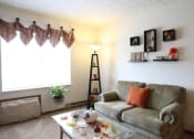 Thumbnail 2 of 18 - Image of a living room with couch, coffee table, and lamp
