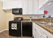 Thumbnail 21 of 36 - Fairway Manor Apartment Homes Kitchen Area