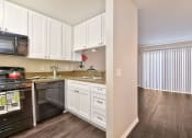 Thumbnail 25 of 36 - Fairway Manor Apartment Homes Kitchen-Living Area