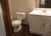 Thumbnail 15 of 21 - Image of bathroom with vanity, mirror, and toilet