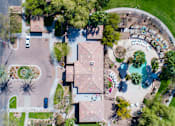 Thumbnail 33 of 37 - Overhead view of entryway into the community, showing rooftop of leasing office, and view of resort style pool at SKY at p83, AZ 85381