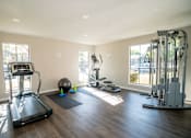 Thumbnail 4 of 11 - Fitness center with treadmill and other gym equipment.