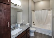 Thumbnail 4 of 37 - A bathroom with a toilet, sink and bathtub at RoCo Apartments, Fargo, ND 58102