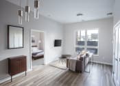 Thumbnail 1 of 37 - A living room with gray walls and hardwood floors at RoCo Apartments, Fargo, North Dakota 58102