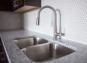 Thumbnail 5 of 37 - A kitchen sink with a faucet in a 555 waverly unit  at RoCo Apartments, Fargo, North Dakota, 58102