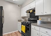 Thumbnail 10 of 17 - Kitchen with gas range and refrigerator at Davis Park Apartments in North Richland Hills TX