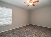 Thumbnail 2 of 28 - Bedroom with ceiling fan and plush carpet flooring at Verano Oaks Apartments