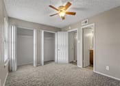 Thumbnail 9 of 28 - Bedroom with ceiling fan and large window at Verano Oaks Apartments