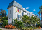 Thumbnail 2 of 8 - front of building with lush landscaping
