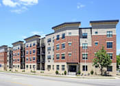 Thumbnail 1 of 12 - Kingston Village - modern apartment buildings with brick and stone exteriors.
