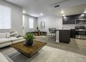 Thumbnail 17 of 34 - Living area with Kitchen and Dining in the Background