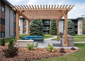 Thumbnail 5 of 46 - Wooden pergola with a bench at Countryside Estates Apartments, Minnesota