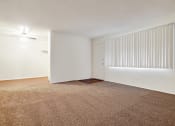 Thumbnail 40 of 48 - Living room with carpeted floors, wood style floors in dining area with ceiling fan