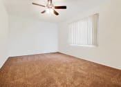 Thumbnail 41 of 48 - Bedroom with carpeted floors, ceiling fan and vertical window blinds on the right