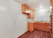 Thumbnail 46 of 48 - Kitchen with double stainless steel kitchen sink, quartz countertops, stainless steel Microwave oven on the right, wood kitchen cabinets, and wood style floors