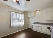 Thumbnail 29 of 48 - Dining area with ceiling fan, wood style floors, open kitchen on the right