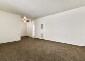 Thumbnail 35 of 48 - Living room with air conditioning, carpeted floors, and wood style floors in dining area