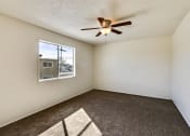Thumbnail 37 of 48 - Bedroom with ceiling fan and carpeted floors