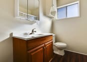 Thumbnail 38 of 48 - Bathroom with wood style single vanity cabinet, hardwood style flooring