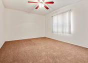 Thumbnail 47 of 48 - Bedroom with ceiling fan and carpeted floors, vertical window blinds on the right