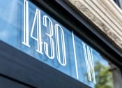 Thumbnail 2 of 25 - a sign on the side of a building