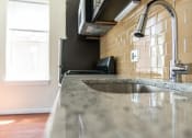 Thumbnail 4 of 25 - a kitchen with a sink and a microwave