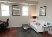 Thumbnail 17 of 25 - a living room with a couch and a table