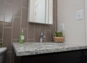 Thumbnail 19 of 25 - a bathroom with a sink and a mirror