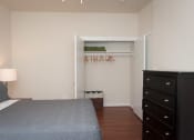 Thumbnail 20 of 25 - a bedroom with a bed and a dresser